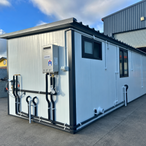 Exterior plumbing and gas water heater on an 8.08m x 2.6m self-contained portable cabin
