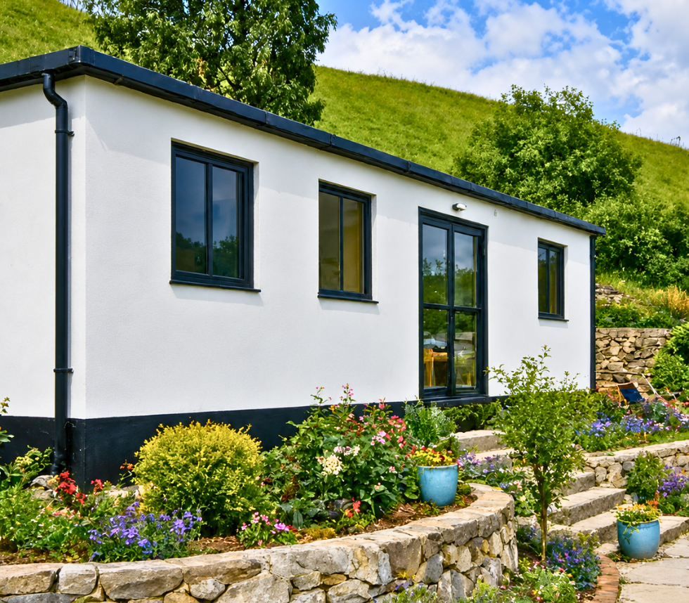 9.3m x 3m self-contained Sunrise Build cabin in a landscaped garden